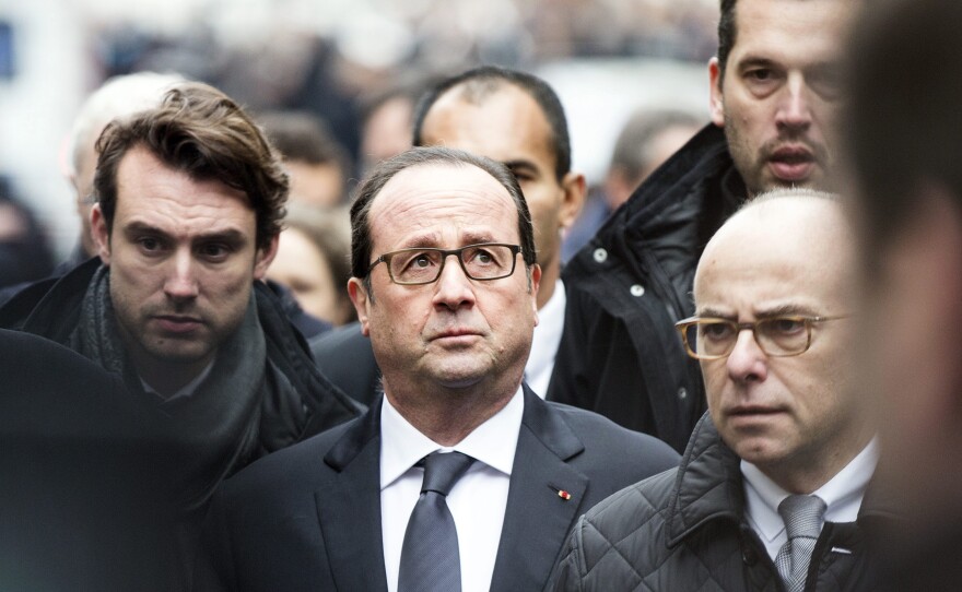 "France today faced a shock," Hollande (center) said, according to a BBC interpreter. "Today, I'm thinking about the victims."