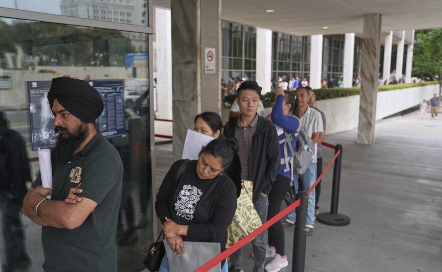 In June 2025, people line up outside the Los Angeles Federal Building, which houses offices for U.S. Immigration and Customs Enforcement and U.S. Citizenship and Immigration Services.
