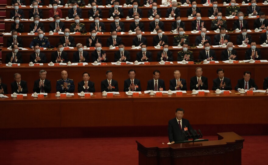 Delegates applaud as Chinese President Xi Jinping speaks.