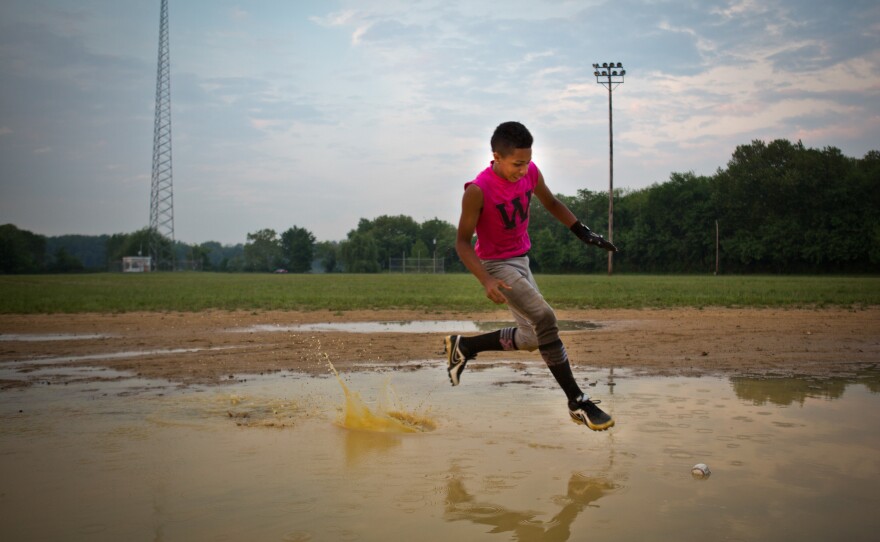 A.J. Ramos bounds across the flooded infield to retrieve a ground ball.