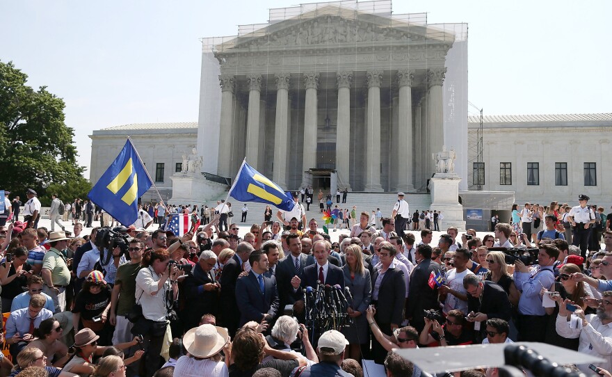 The court also cleared the way for gay marriages to resume in California. One of the attorneys in that case, David Boise (center), speaks as he's surrounded by plaintiffs in the case, couples Paul Katami (from left) and Jeff Zarrillo, and Sandy Stier and Kris Perry.