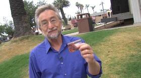 Bret Fisher holds up his Gold State Advantage card, which gives him access to CalFresh benefits, May 5, 2017.