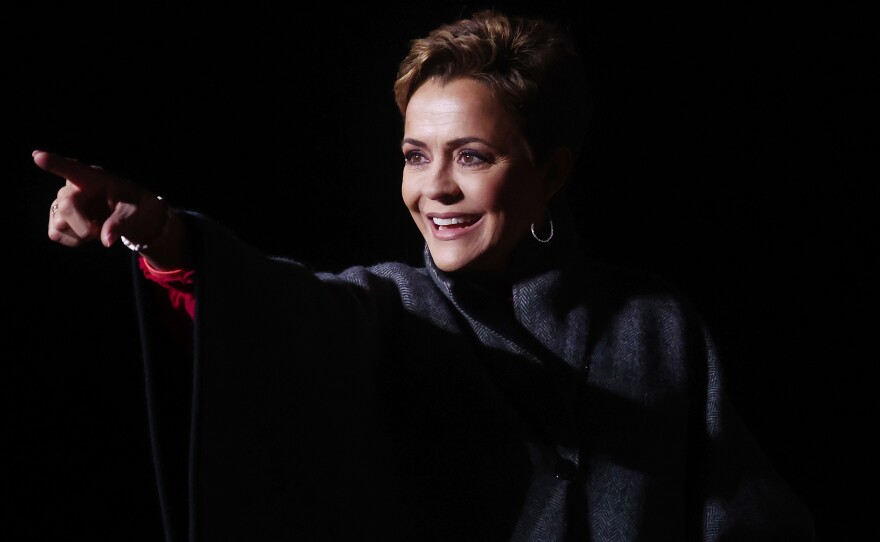 Republican candidate for Arizona governor Kari Lake points to the crowd at a rally for former President Donald Trump on Jan. 15 in Florence, Ariz. Lake's introductory campaign ad included baseless claims of a rigged 2020 election.