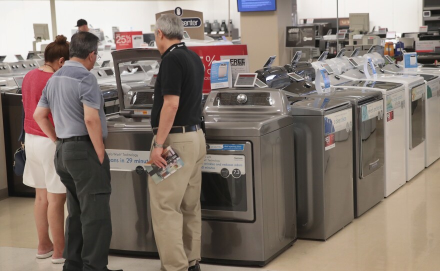 Shoppers look at appliances at a Sears store in Schaumburg, Ill. At nearly $13 trillion, consumer debt has topped the previous record set during the financial crisis.