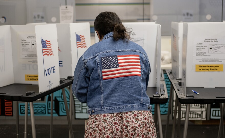 A voter casts their ballot at the Hillel Foundation on Tuesday in Madison, Wis.