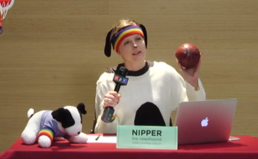 Nipper the Newshound, played by NPR staffer Becky Harlan, talks to the hosts during NPR Live's NCAA Men's Basketball Tournament show. Nipper (the dog) is NPR's unofficial mascot and an affectionate name for NPR staffers.