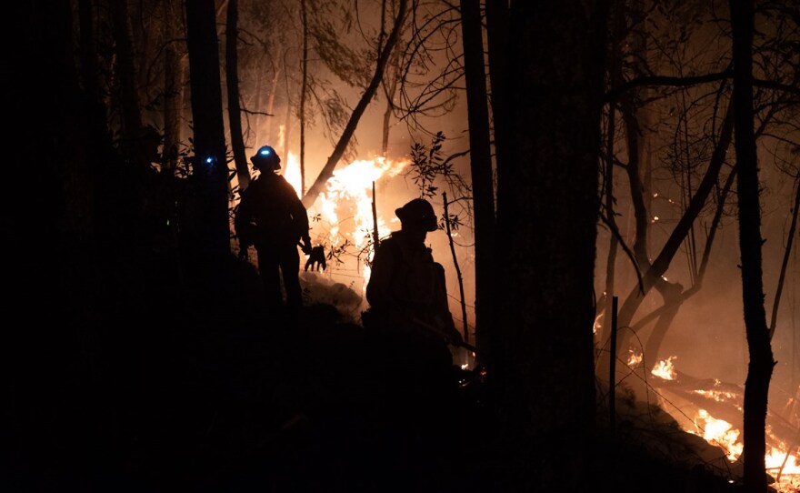 Firefighters monitor a backburn outside Calistoga, CA Thursday, Oct 1, 2020.