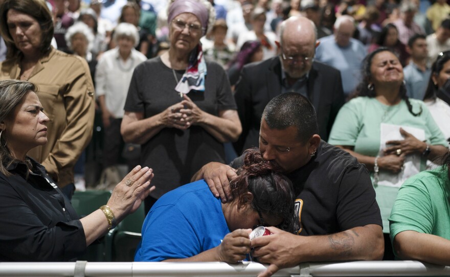 Two family members of one of the victims killed in Tuesday's shooting at Robb Elementary School comfort each other during a prayer vigil in Uvalde, Texas, Wednesday, May 25, 2022.