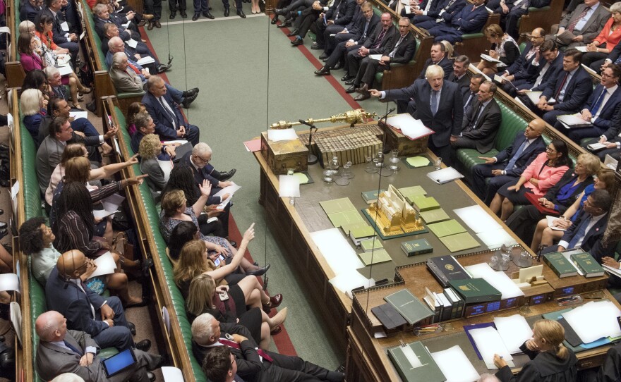 Prime Minister Boris Johnson (center right) gestures during his first Prime Minister's Questions in London Wednesday. The U.K.'s House of Commons voted to block a no-deal Brexit, prompting Johnson to call for a general election next month — which was also voted down.