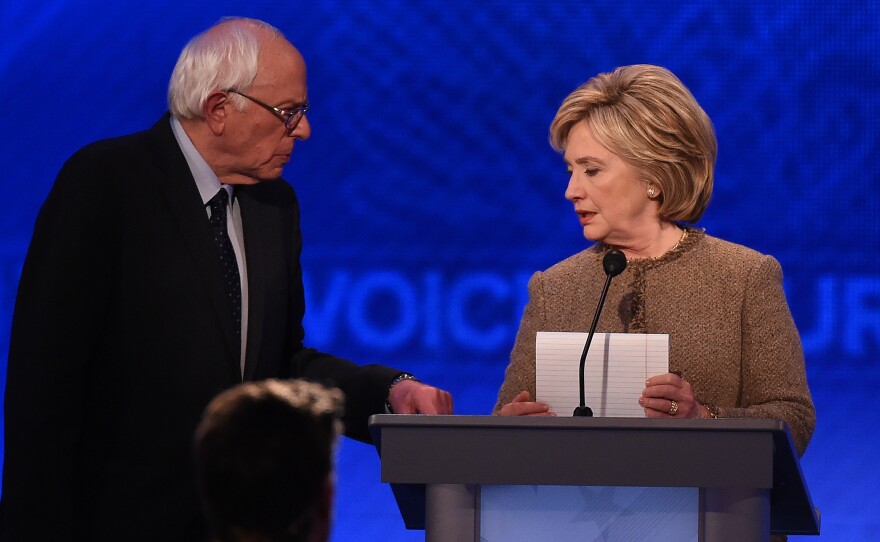Bernie Sanders, left, and Hillary Clinton confer during a break in a December Democratic presidential debate in New Hampshire.