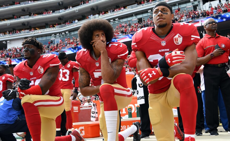 Then-San Francisco 49ers quarterback Colin Kaepernick kneels during the national anthem in a game against the Dallas Cowboys last year.