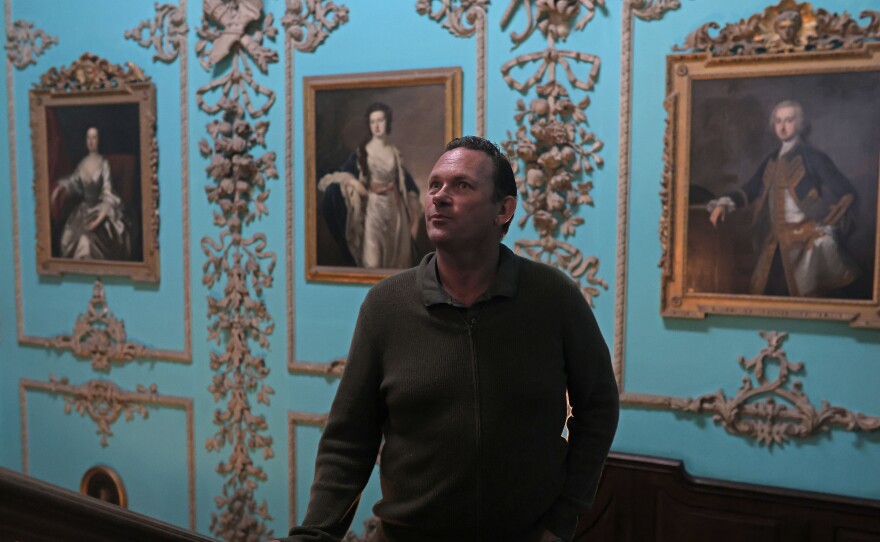 Aristocrat Charles Courtenay, 19th Earl of Devon, pictured alongside portraits of his ancestors at his family seat.