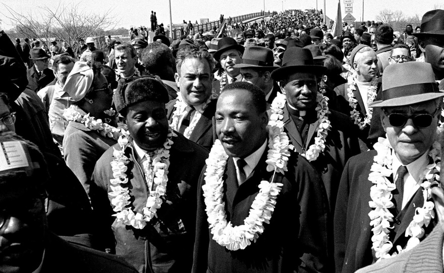 The nonviolent actions of Dr. King inspired young Kennedy Odede. In this March 21, 1965 file photo, King leads a civil rights march across the Edmund Pettus Bridge in Selma, Ala., to protest voting laws.