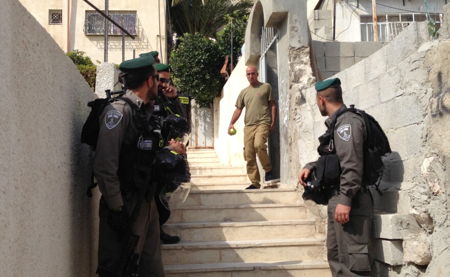 Israeli police stand near a residence in East Jerusalem where Israeli Jews have bought apartments in the predominately Palestinian neighborhood of Silwan. The Palestinian seller said he sold the apartment to a Palestinian middleman and did not realize the ultimate owner was Jewish.