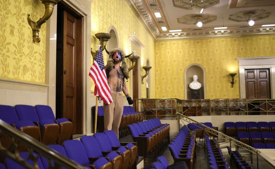 A protester screams "Freedom" inside the Senate chamber after the U.S. Capitol was breached by a mob on Jan. 6, 2021. Retired U.S. Maj. Gen. Paul Eaton suggests better civics lessons could help prevent another insurrection.