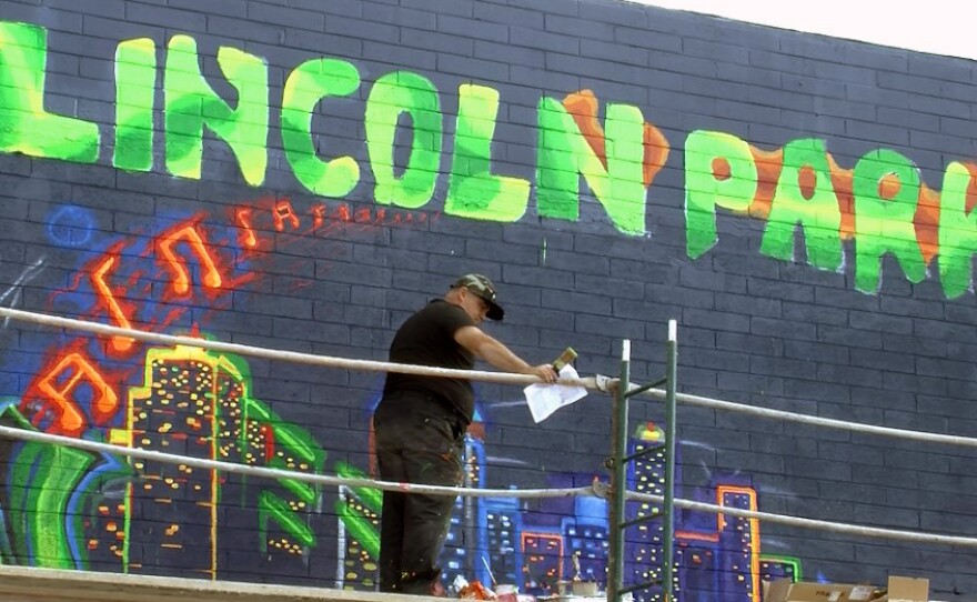 Mike Rosenblatt works on a mural in the Lincoln Park neighborhood, Dec. 6, 2016.