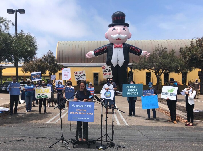 Community solar advocates rally at the Chula Vista Library Wednesday to protect the state's rules for rooftop solar customers on Jun. 2, 2021.
