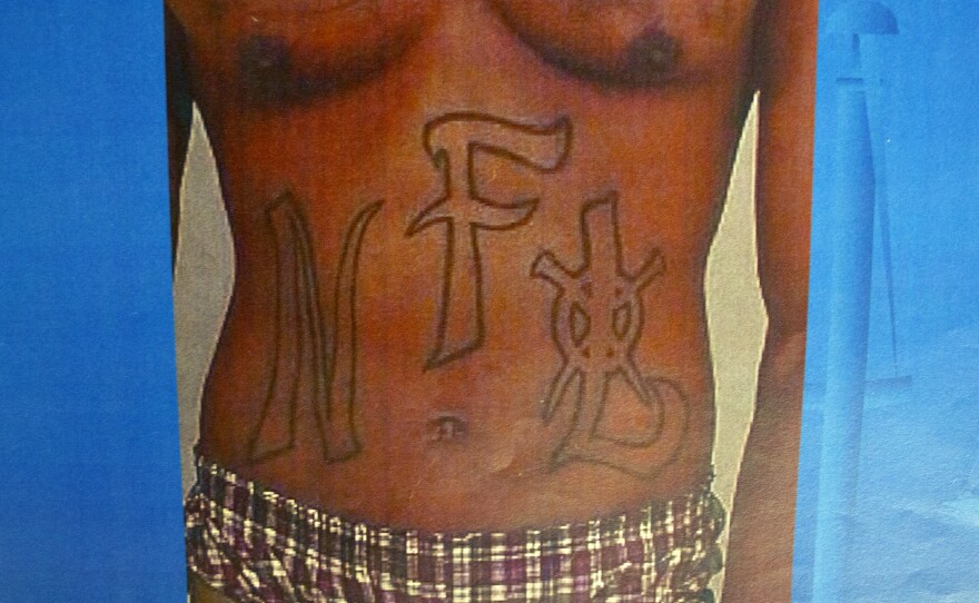 Photos of evidence from the James Carter case showing what prosecutors say are gang tattoos on James Carter.