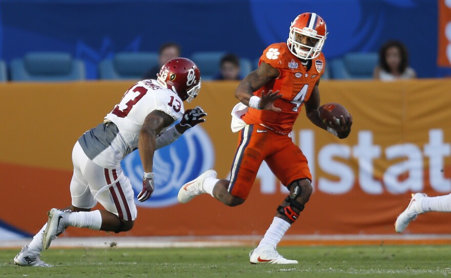Clemson quarterback Deshaun Watson runs past Oklahoma's Ahmad Thomas during the college playoff semifinal game on New Year's Eve. Clemson won 37-17.
