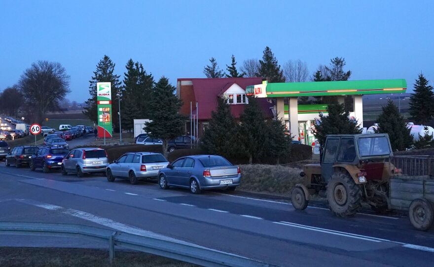 People wait for gas at the station near Ukraine's border with Poland after Russian President Vladimir Putin authorized a military operation in Ukraine.