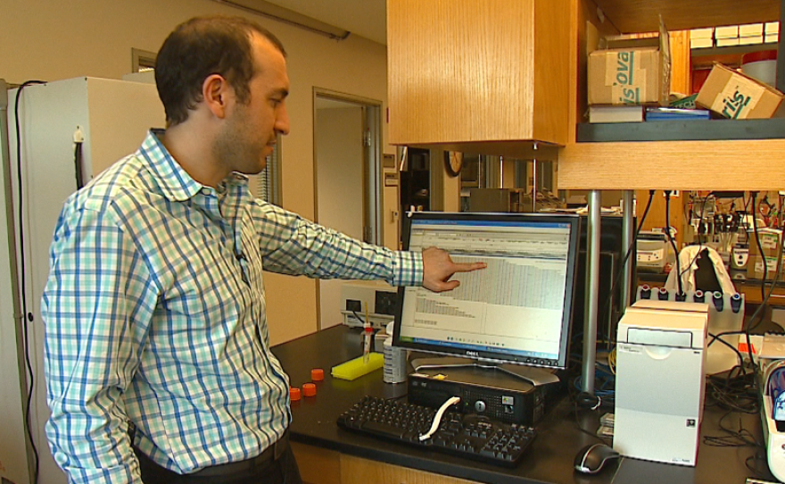 Scripps researcher Ali Torkamani indicates a mutation on the TRPM4 gene, Feb. 22, 2016.
