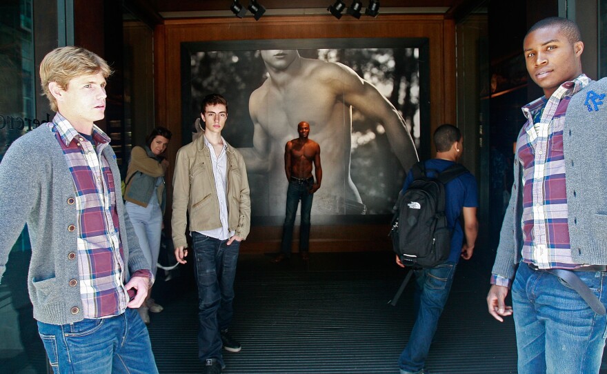 A model at the front entrance to the Abercrombie & Fitch flagship store in New York City.