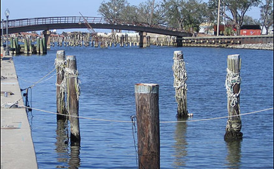 The 17th St. Canal, with its footbridge, was a Bucktown landmark. Fisherman tied their boats to the wooden pilings in the foreground.
