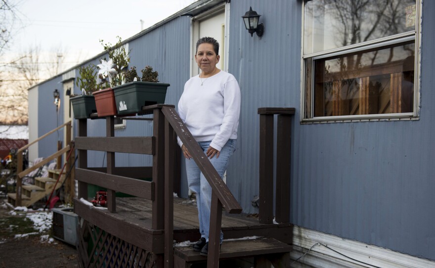Natividad Seefeld, who's the president of the Park Plaza cooperative, stands outside her home. She and other residents say prior to becoming a cooperative, they had never seen the owner.
