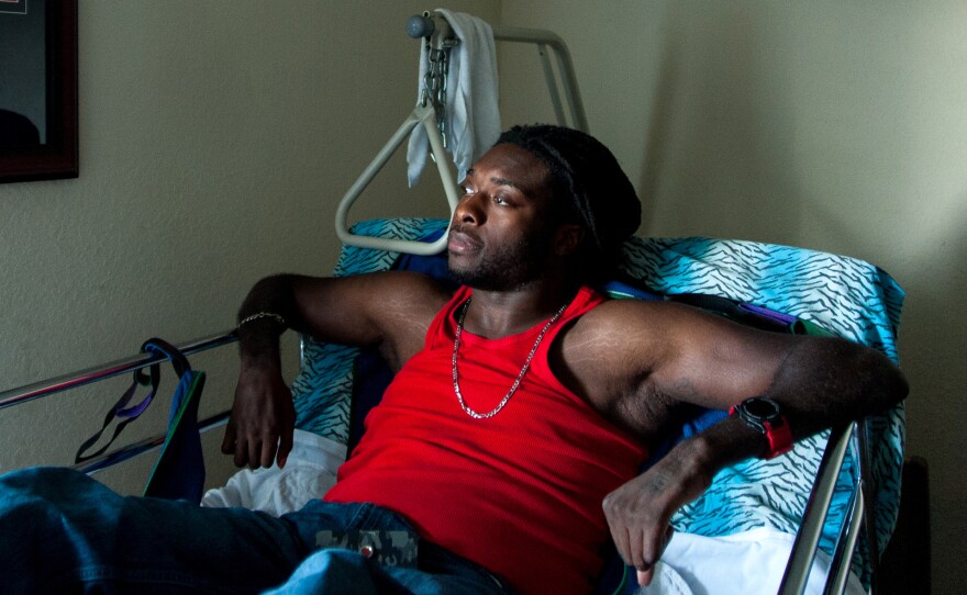 Emeka Nnaka sits in his bed during a pause in text messages from friends as he makes plans for the evening.