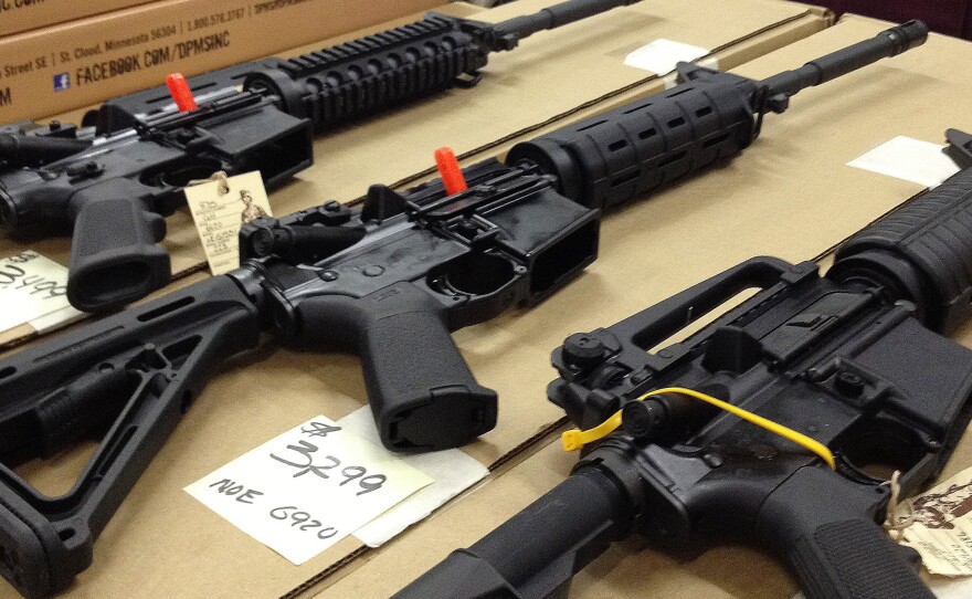 Rifles are displayed at a gun show in Marietta, Ga., on Dec. 22, 2012. A new poll shows overwhelming and bipartisan support for requiring criminal background checks before the sale of firearms at gun shows, as is already required before store sales.