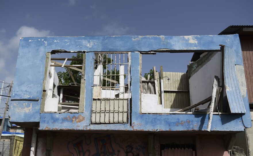 In this June 13 photo, a residence in the Figueroa neighborhood stands destroyed nine months after Hurricane Maria, in San Juan, Puerto Rico. On Wednesday a federal judge extended a temporary housing program for territory residents whose homes were destroyed.