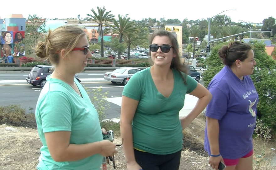 Mural designer Brise Birdsong talks with other volunteers.