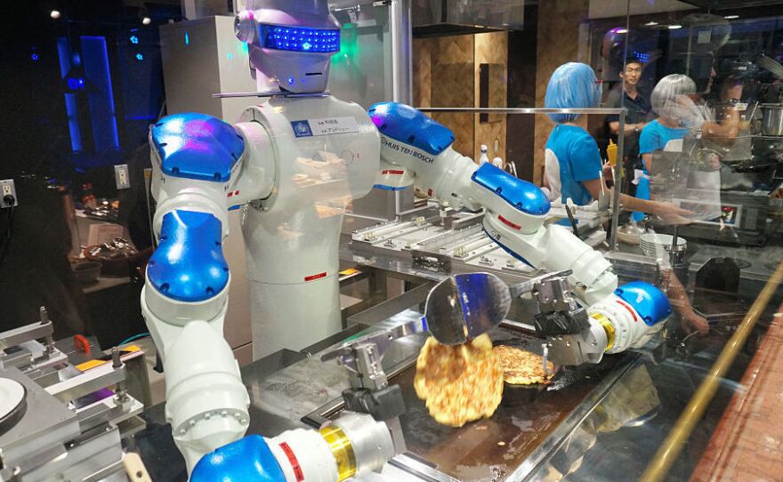 Head chef robot "Andrew" flips Japanese pancakes during the "Kingdom of Robot" press preview at the Huis Ten Bosch amusement park on July 12 in Sasebo, Nagasaki, Japan.