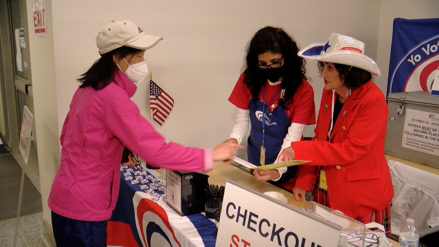 Voter registration personnel sport festive attire while accepting voter ballots at the Registrar of Voters in Kearny Mesa, Nov. 8, 2022.