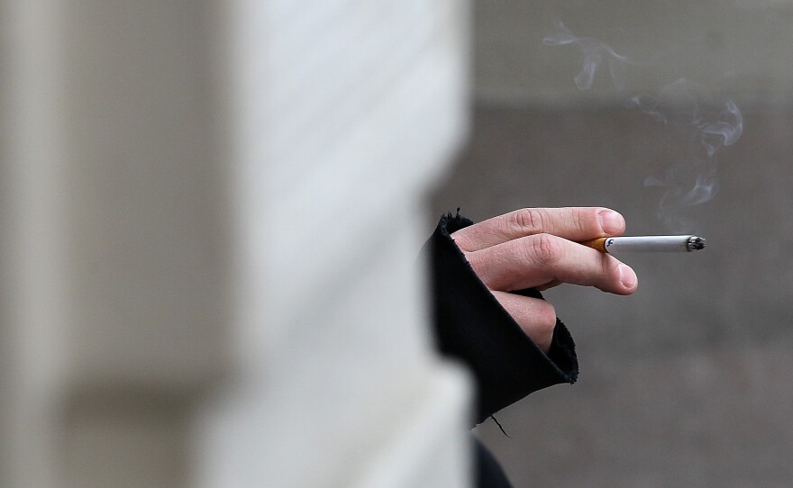 A smoker in San Francisco holds a cigarette. If Gov. Jerry Brown signs the bill, California will become the second state to raise the age limit for buying tobacco products from 18 to 21.