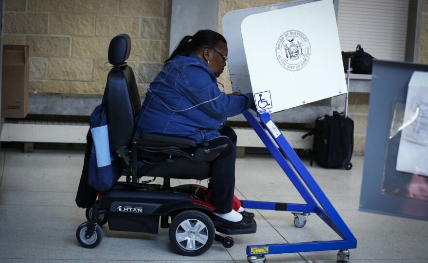 A woman casts her vote at a polling station in Brooklyn in the New York state presidential primary on April 19.
