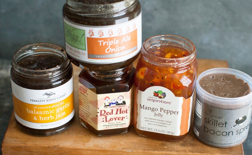 This 2014 photo shows an assortment of savory jams. From left to right, Terrapin Ridge Farms balsamic garlic and herb jam, Wozz Kitchen Creations triple ale onion jam, The Prairie Gypsies red hot lover jam, Taste of Inspirations mango pepper jelly, and Skillet Bacon Spread original bacon spread.