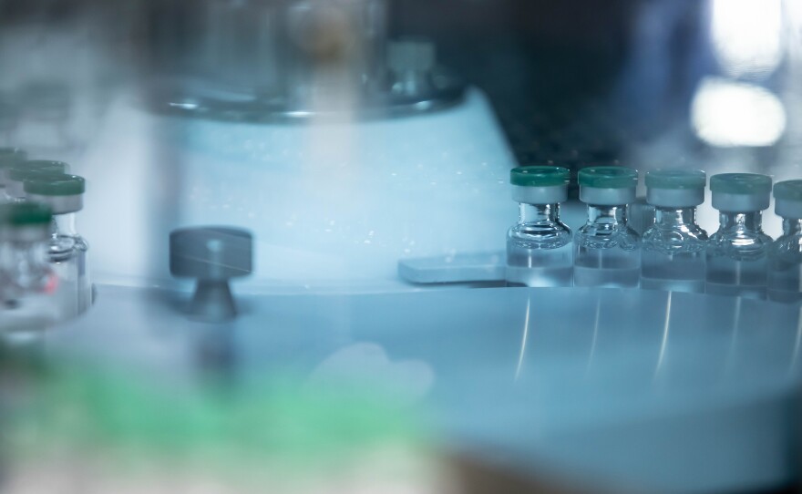 A visual screening machine that checks for any deficiencies in the vaccine substance or bottling.