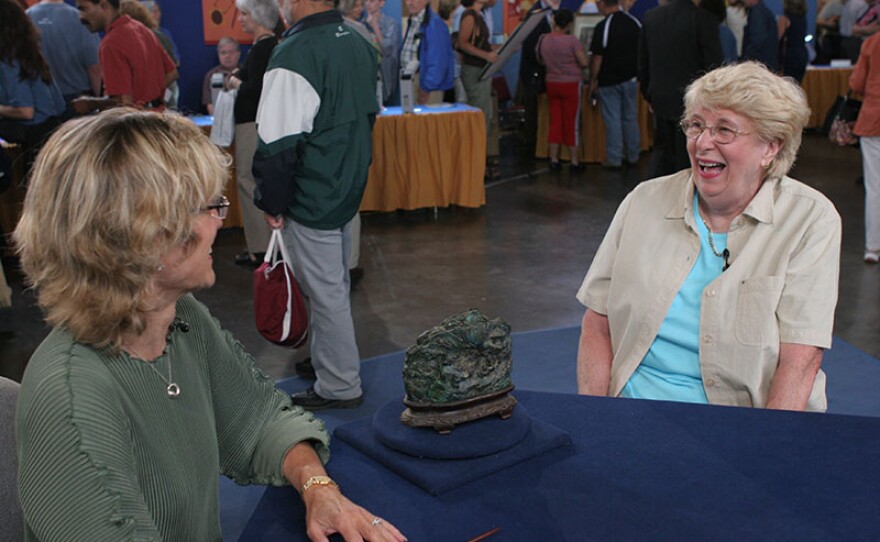 Dessa Goddard (left) appraises a late 18th C. Chinese scholar's mountain in Providence, R.I.