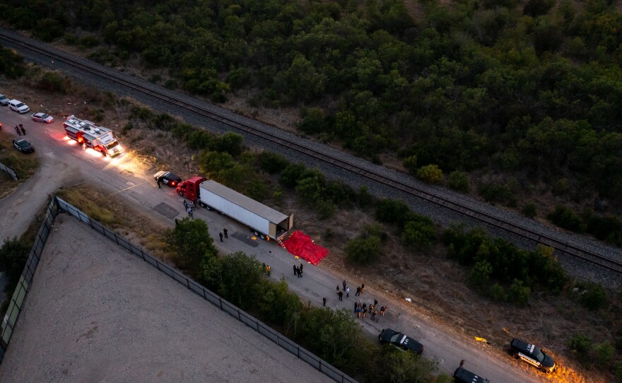 In this aerial view, members of law enforcement investigate a tractor trailer on Monday in San Antonio, Texas.
