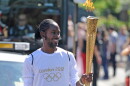 FILE — Torchbearer Jason Arday carries the Olympic Flame on the Torch Relay leg between Sutton and Merton, in London, July 23, 2012.