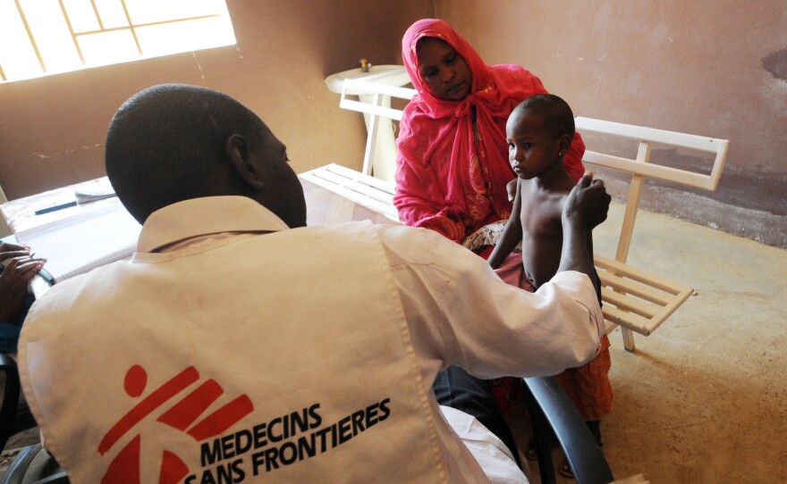A worker from Doctors Without Borders speaks with a sick child in Gao, in the north of Mali, on Feb. 4.