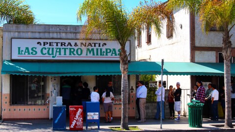 A line of people wait to order at the former location of Las Cuatro Milpas in this undated image.