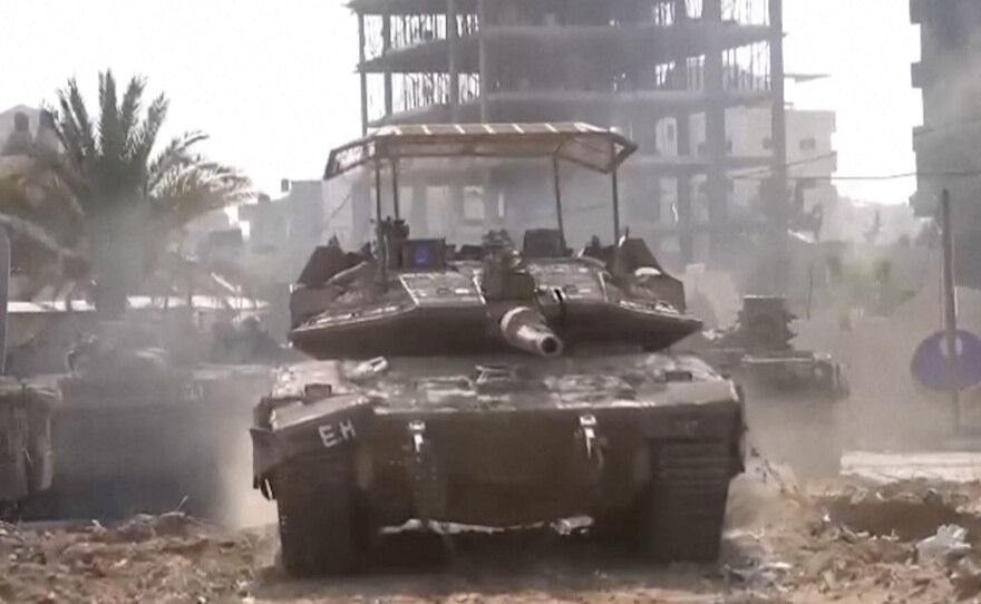 In this image taken from a video released by the Israel Defense Forces on Tuesday, an Israeli tank drives through Gaza City.