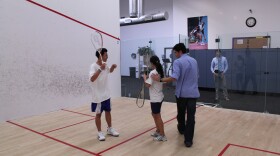 Squash coach Renato Paiva helps Access Youth Academy team members Ana Rodriguez and Eric Huynh polish their game, February 7, 2011. 