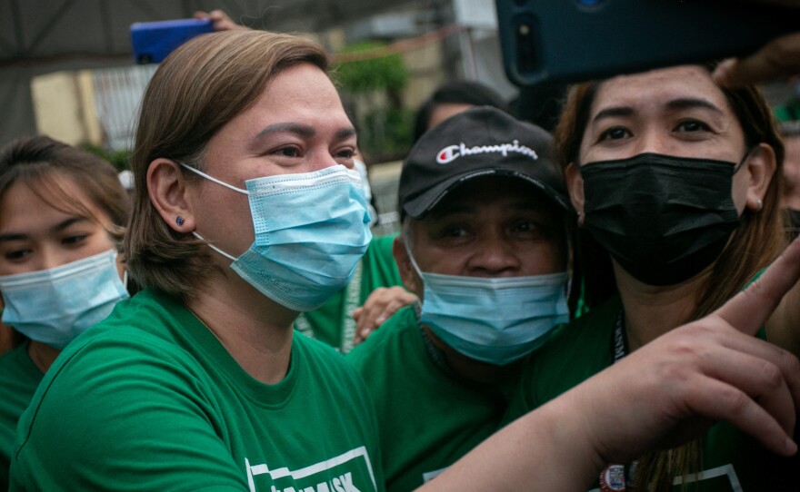 Sara Duterte poses for a selfie with city hall employees in Davao city, on the southern island of Mindanao.