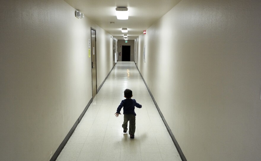 An asylum-seeking boy from Central America runs down a hallway after arriving at a shelter in San Diego, December 2018.