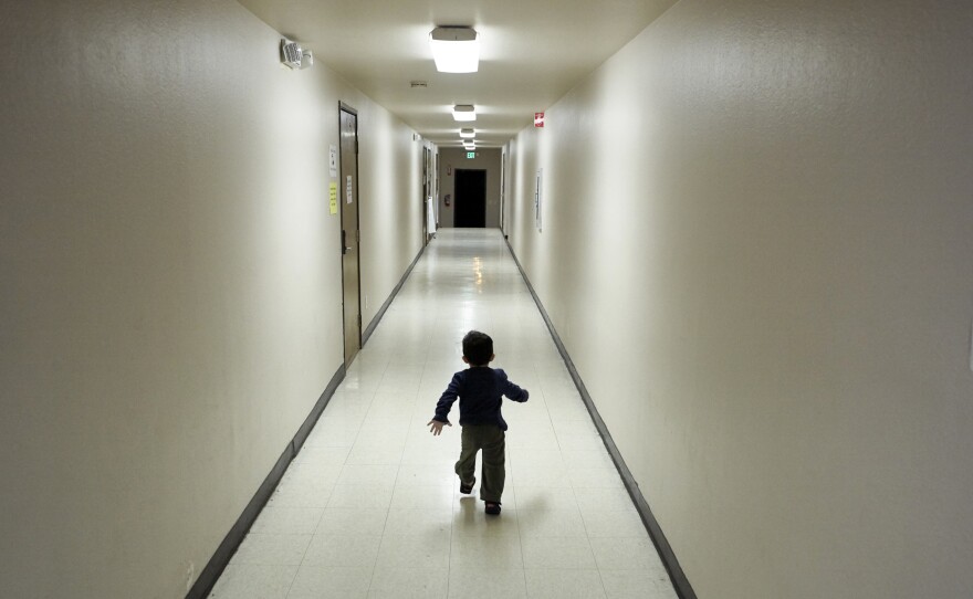 An asylum-seeking boy from Central America runs down a hallway after arriving at a shelter in San Diego, December 2018. 