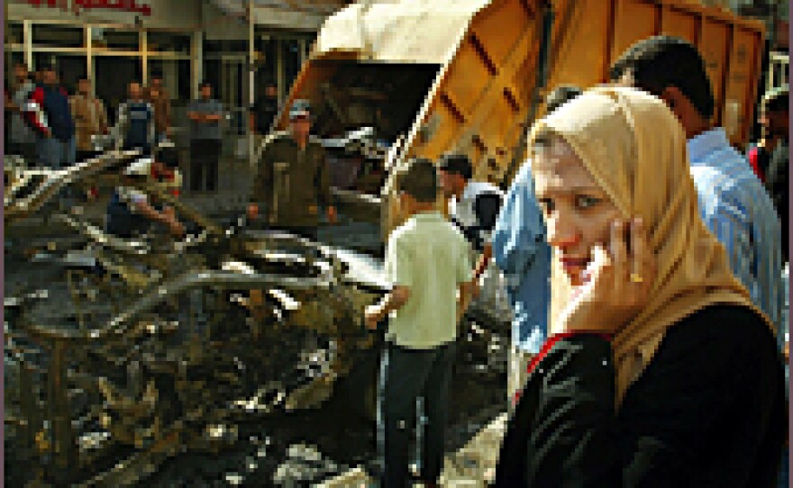 Iraqis gather at the site of a car bomb explosion near a crowded restaurant on Nov. 12, 2006. Attacks in and around Baghdad, including a double suicide attack at a recruiting center, left 45 people dead Sunday.