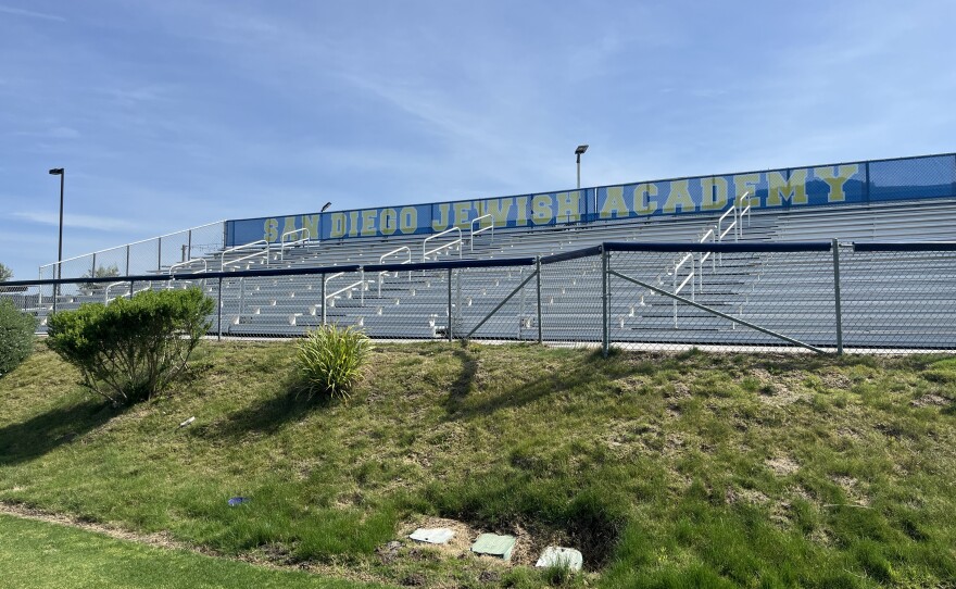 The bleachers above San Diego Jewish Academy's soccer fields display blue and yellow lettering of the school's name, March 16, 2026.